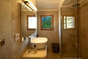 a bathroom with a tub and a sink and a shower at Résidence Les Toits de Santa Giulia in Porto-Vecchio +78 photos