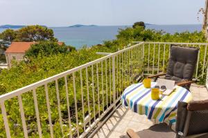 einen Tisch und Stühle auf einem Balkon mit Meerblick in der Unterkunft Apartments Villa Mare in Mlini