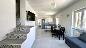 a kitchen and living room with a couch and a table at SE104 - Elegante quadrilocale comodo ai servizi in Senigallia