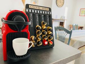 a coffee maker with a cup of coffee on a table at Les chambres d'hôtes des Perdrix in Le Petit Hanche