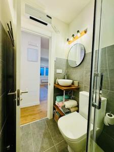 a bathroom with a toilet and a sink at Casa Yaya confortllanes in Colunga