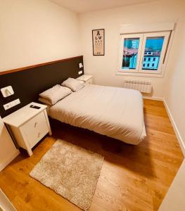 a bedroom with a large bed and a window at Casa Yaya confortllanes in Colunga