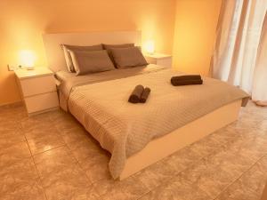 a bedroom with a large bed with two objects on it at oLive Home in Alexandroupoli