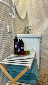 a bathroom with a sink and a shelf under a sink at Naujos statybos namelis in Palanga