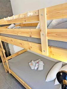 a bunk bed with two slippers on the floor at A 150 metros del Mar, Parking Gratis, AC in Santa Pola