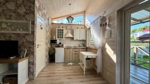 a small kitchen with a table and a window at Naujos statybos namelis in Palanga