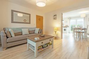 a living room with a couch and a table at The Seahouse in Portreath
