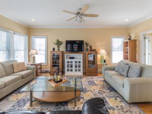 a living room with two couches and a tv at 1 Pleasure Island in Kure Beach