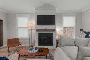 a living room with a couch and a fireplace at Sparkys Den by Seabrook Hospitality in Pacific Beach