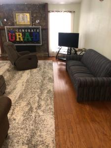 a living room with a couch and a television at Pond view House in Snellville