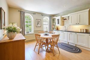 a kitchen with a table and chairs in a room at Host & Stay - May Cottage in Middleton One Row +15 photos