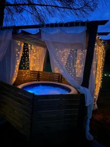 a hot tub in a backyard at night with lights at Les jardins de Manotte in La Motte