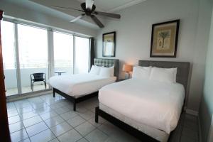 a hotel room with two beds and a window at Castle PH12 Spacious Bay View Penthouse, Pool, Tennis, Free Parking in Miami Beach +51 photos