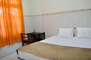 Letto o letti in una camera di Garuda Setia Hotel