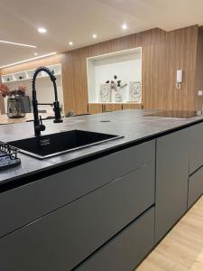 a kitchen with a sink and a counter top at Apartamento Miño in Tui +13 photos