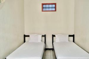 Letto o letti in una camera di Garuda Setia Hotel