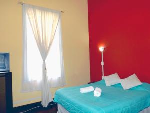 Säng eller sängar i ett rum på Hostal Pacifico Norte