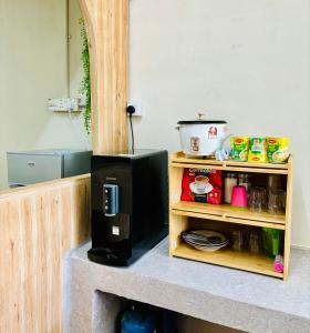 a microwave sitting on a counter in a kitchen at Selesa Homestay , Tingkat 1 di Bandar Jeli in Jeli