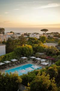 a view of a pool with chairs and umbrellas at Boutique Hotel Casa Mariantonia in Anacapri
