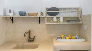 a kitchen counter with a sink and a faucet at Anastasia's Triovasalos in Triovasálos +33 photos
