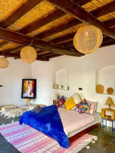 a living room with a bed and a couch at Oceanside Surf & salsa in Aourir