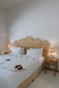a bedroom with a large white bed with two tables at Sentidos Beach Retreat in Miramar