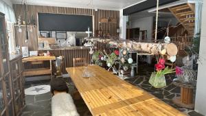 a room with two wooden tables and a large screen at Jokimaja BoutiqueHotel in Köngäs