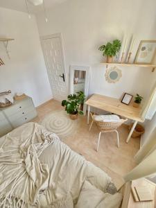 ein Schlafzimmer mit einem Bett, einem Schreibtisch und einem Tisch in der Unterkunft La Casita de Mamacita in Los Alcázares