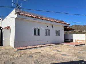 a white building with windows and a roof at Casa Don Daniel in Arona