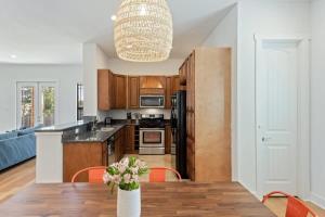 a kitchen with a table with a vase of flowers at Bright Home in East ATX - 3BR - Cowboy Pool in Austin