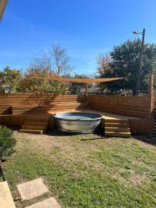 a large wooden deck with a tub in a yard at Bright Home in East ATX - 3BR - Cowboy Pool in Austin