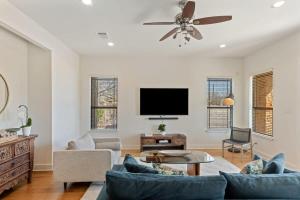 a living room with a couch and a flat screen tv at Bright Home in East ATX - 3BR - Cowboy Pool in Austin