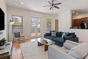a living room with a blue couch and a table at Bright Home in East ATX - 3BR - Cowboy Pool in Austin +25 photos