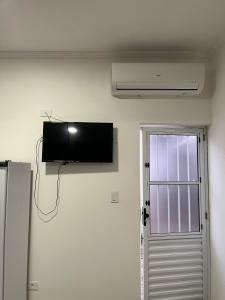 uma televisão de ecrã plano na parede de um quarto em Flats Bem Te Vi - Praia Grande em Ubatuba mais 39 fotografias