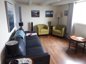 a living room with a couch and two chairs at Lands End Vacation Home in Twillingate