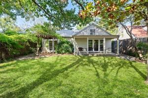 a house with a large yard with a tree at Historic 2 bd Home Patio DT Fredericksburg in Fredericksburg
