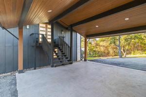 an empty porch of a house with a staircase at Atlantis - Front Row View of Lake Travis in Leander
