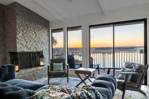 a living room with a couch and a fireplace at Atlantis - Front Row View of Lake Travis in Leander