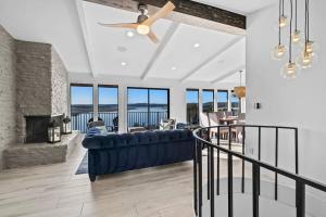 a living room with a blue couch and a fireplace at Atlantis - Front Row View of Lake Travis in Leander