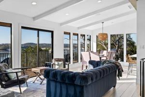 a living room with a blue couch and chairs at Atlantis - Front Row View of Lake Travis in Leander +65 photos