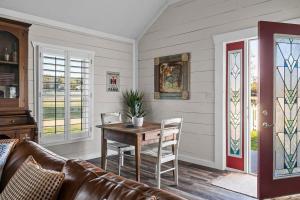 a living room with a table and a couch at Kingsby Cottage - 1 Bedroom w Mountain views in Boerne