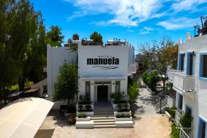 a white building with a sign that reads mamaica at Manuela Boutique Hotel Bitez in Bitez