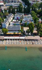 an aerial view of a beach with chairs and buildings at Manuela Boutique Hotel Bitez in Bitez