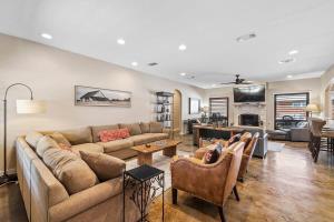 a living room with a couch and a table at 4 Bedroom Close to Downtown Hot Tub-Pool in Fredericksburg