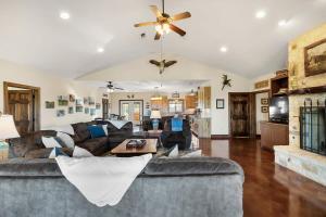 a living room with a couch and a ceiling fan at Enchanted Rockview House - 3 Bedroom - Firepit in Fredericksburg +36 photos