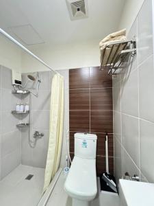 a bathroom with a toilet and a shower and a sink at Bamboo Bay Community with Free Wifi, Pool and Gym in Mandaue City +27 photos