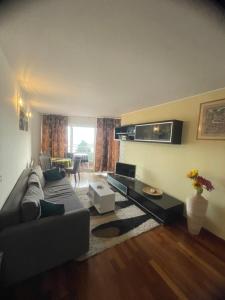 a living room with a couch and a table at Apartments Villa Dinka in Opatija