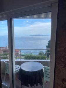 a balcony with a table and a view of the ocean at Apartments Villa Dinka in Opatija