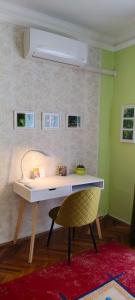 a desk with a chair in a room at Arianna Apartman in Miskolc