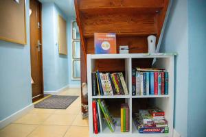 a book shelf filled with books in a hallway at Orle Gniazdo in Władysławowo